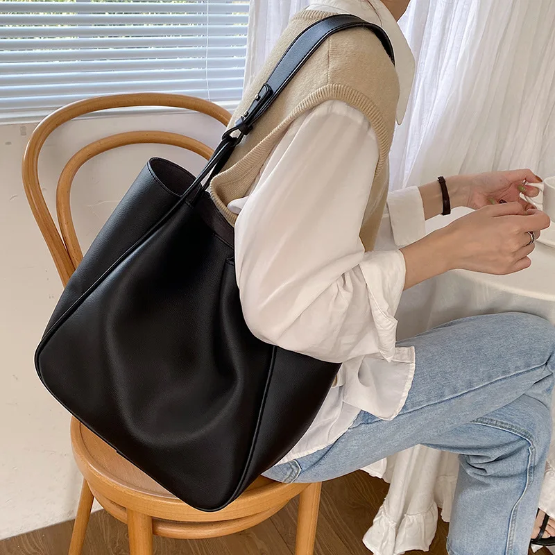 Versatile leather work tote with multiple carrying options for professional women