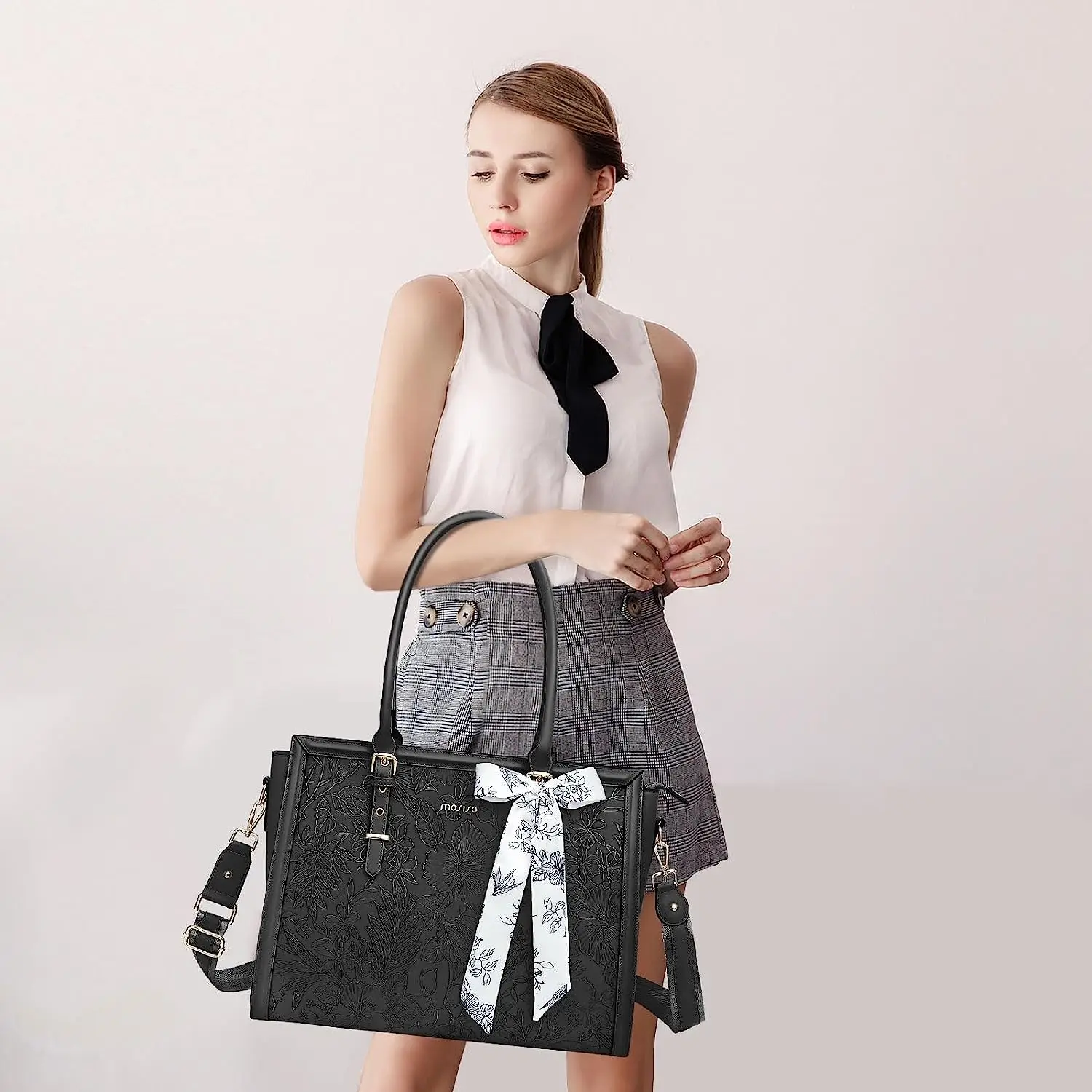 Professional woman with elegant leather work tote for polished business appearance