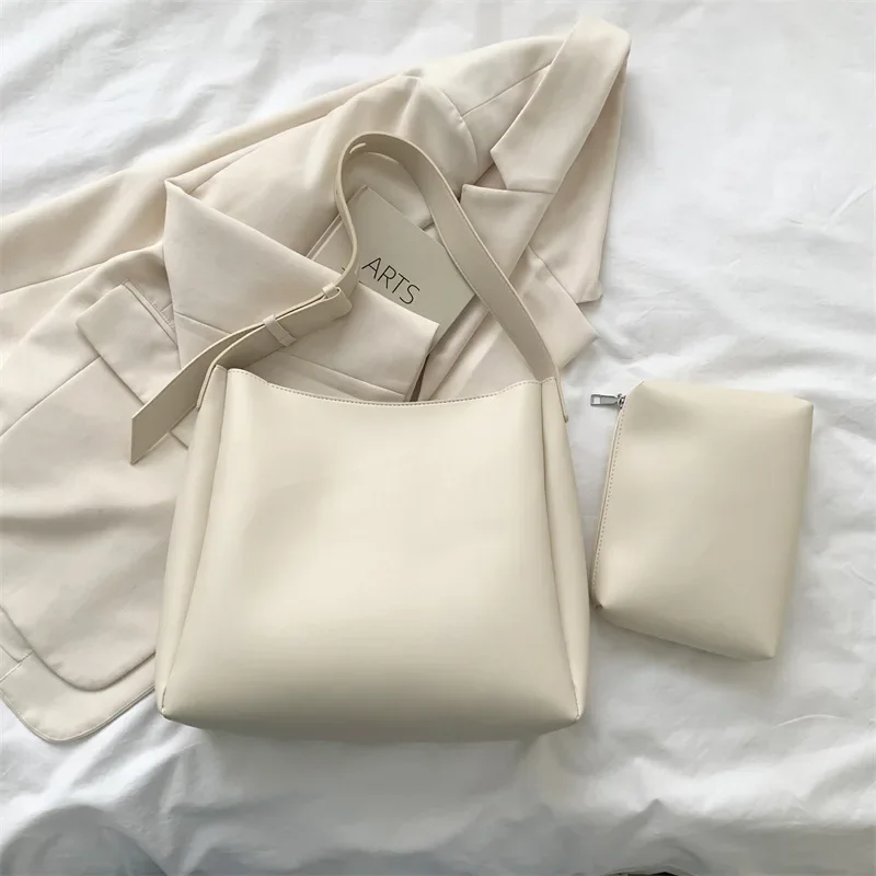 Professional applying leather conditioner to maintain bag suppleness