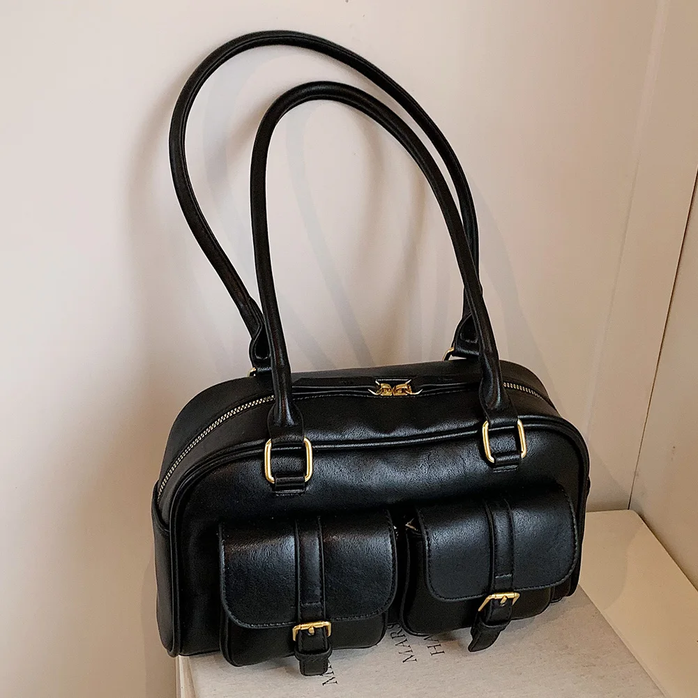 Versatile leather shoulder bag with clean design suitable for any gender presentation