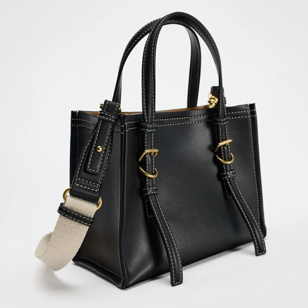 Modern professional woman with sleek leather work tote for business environments